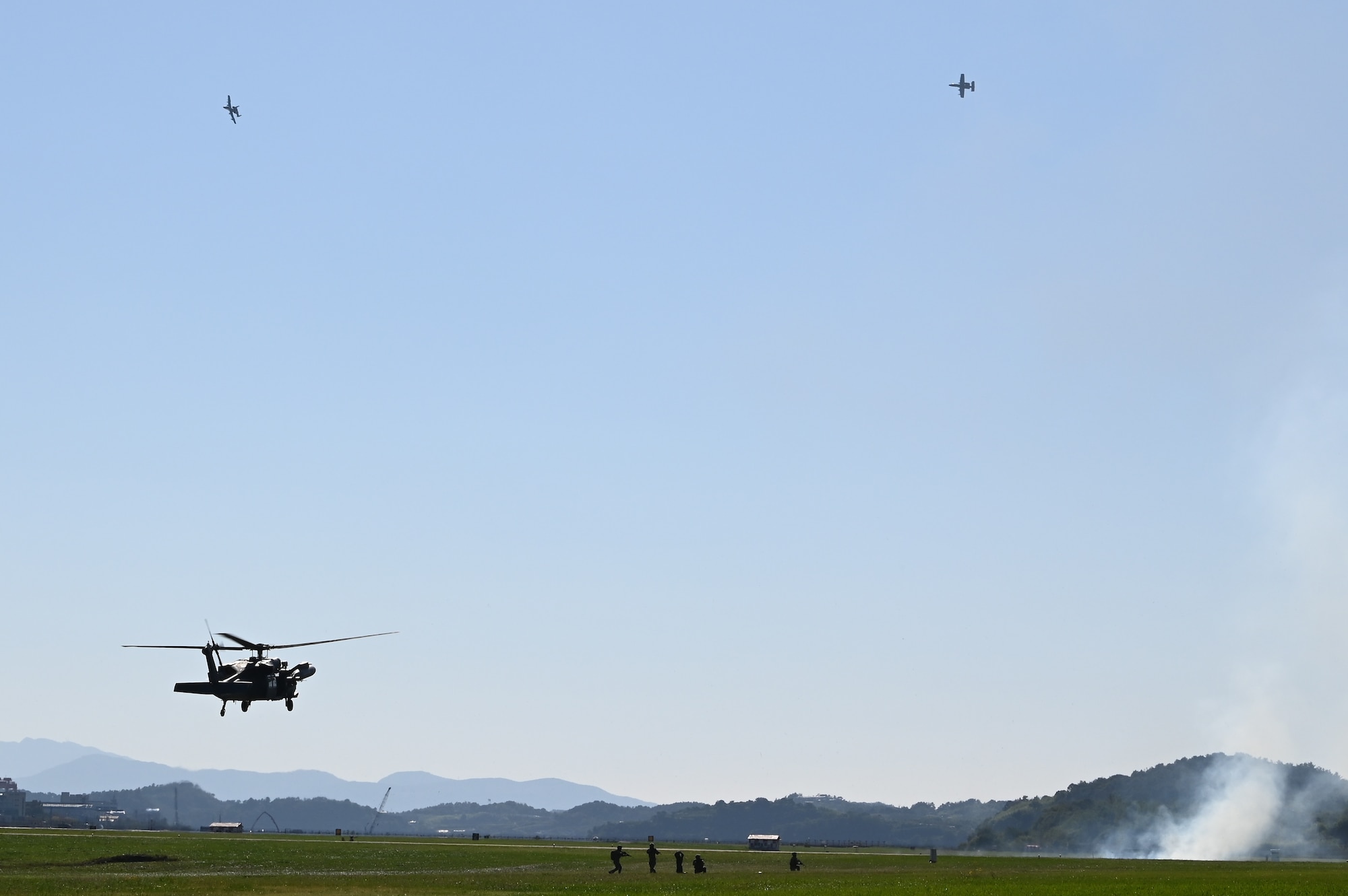 Two 25th Fighter Squadron A-10 Thunderbolt II aircraft provide cover during a combat search and rescue demonstration at the Sacheon Airshow 2024 in Gyeongnam, Republic of Korea, Oct. 24, 2024. The Sacheon Airshow is a biennial event and the U.S. provides support to demonstrated continued commitment to the ROK-U.S. Alliance, signalling flexibility, readiness, resolve and continued support toward deterrence. (U.S. Air Force photo by Master Sgt. Rachelle Coleman)