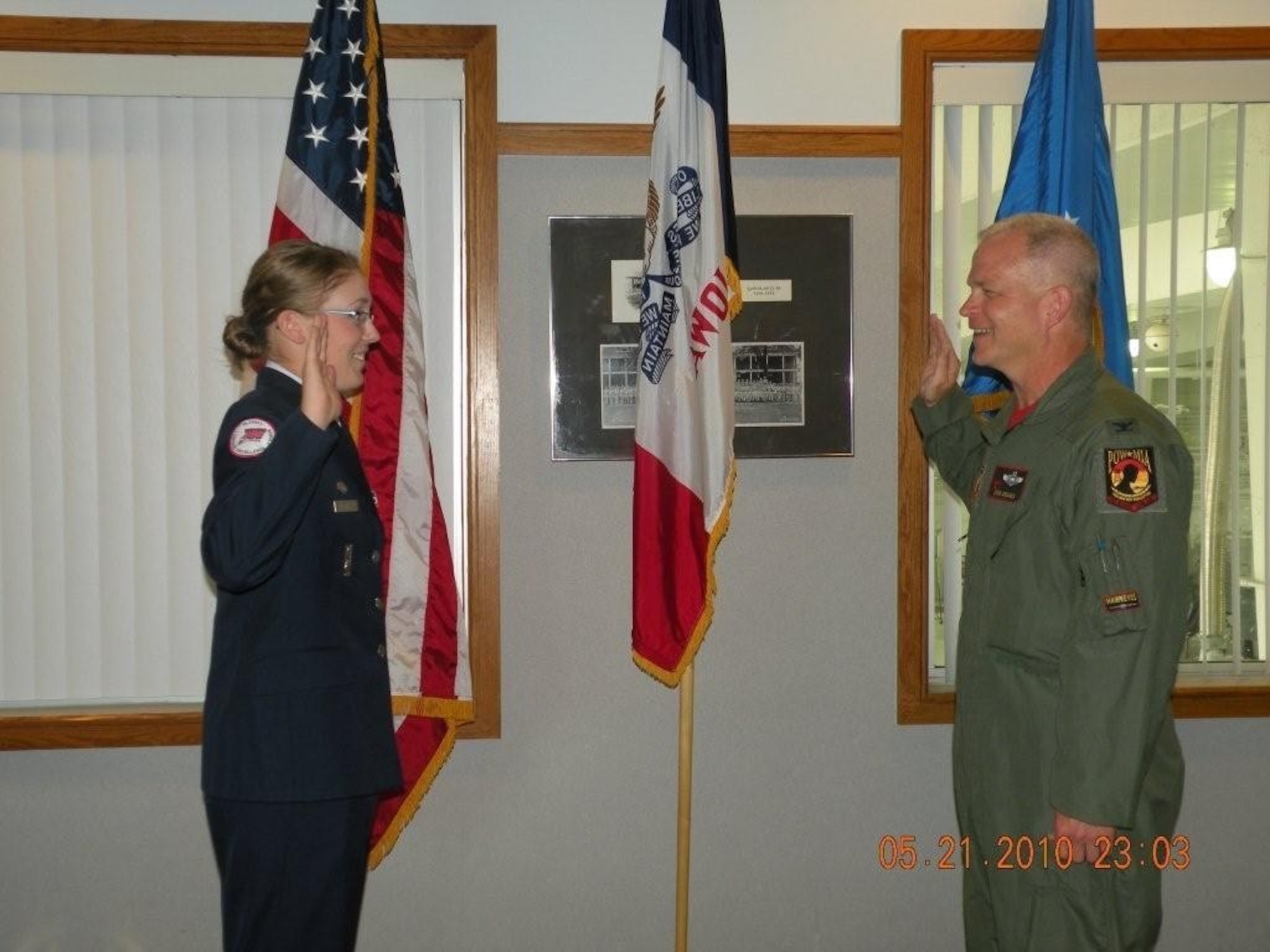 Andrea Bartlett, left, receives her oath of enlistment from Col. William D. DeHaes, Commander of the 132nd Fighter Wing.