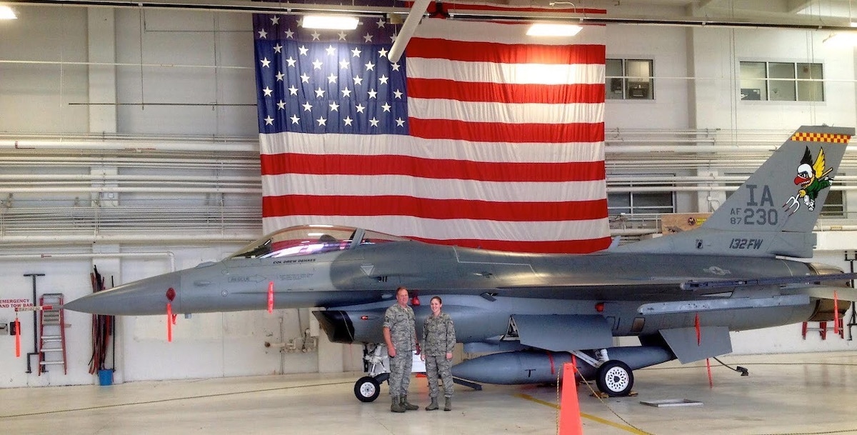 Andrea Bartlett stands with her father in front of an F-16 Falcon during a drill weekend with the 132nd Fighter Wing of the Iowa National Guard in 2012.