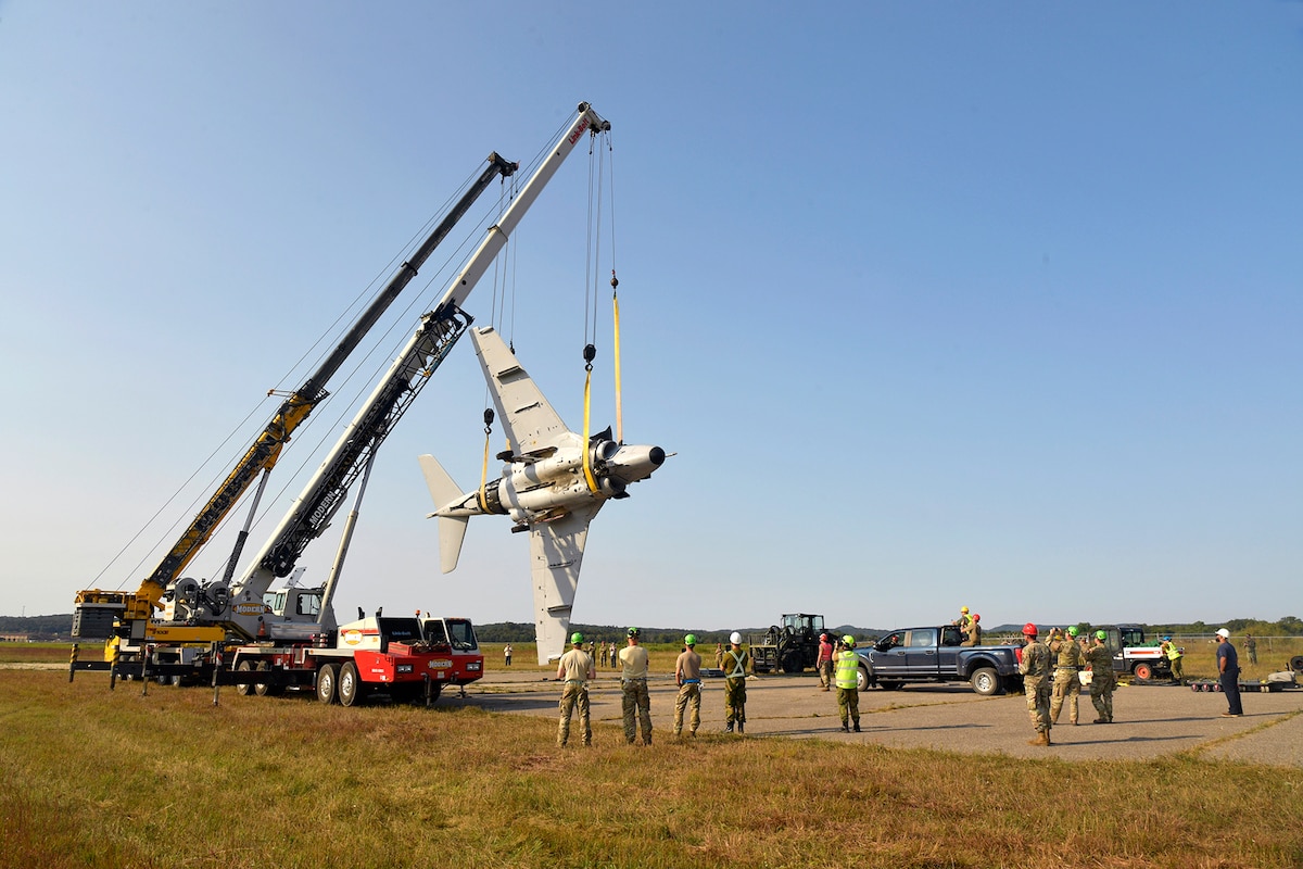 Experienced aircraft recovery personnel from around the world, including participants from the U.S. Air Force, Navy, and Marines, as well as teams from five F-35 foreign partner countries, practice aircraft crane lift procedures on an A-6 training aircraft Sept. 11, 2024, at Volk Field Air National Guard Base, WI. This training, organized by the F-35 Joint Program Office, aimed to share techniques and methodologies, and build international relationships during the advanced CDDAR training exercise for the F-35 global enterprise. (U.S. Air Force photo by Todd Cromar)