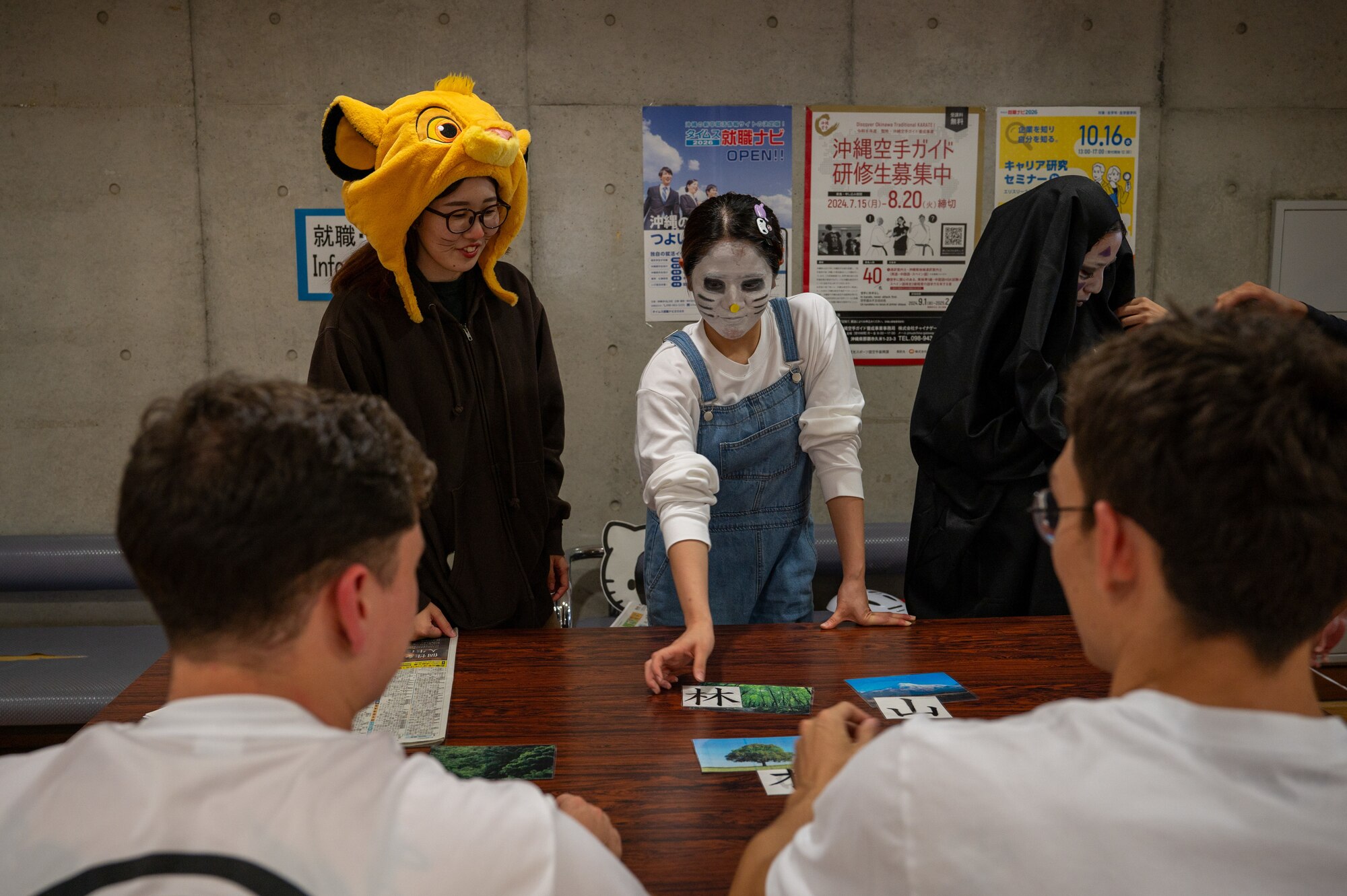 KLI student teaching kanji to volunteers