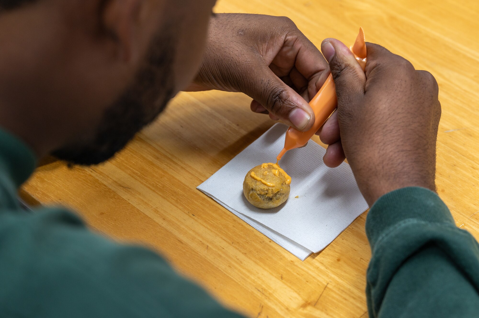 Volunteer decorating a pastry
