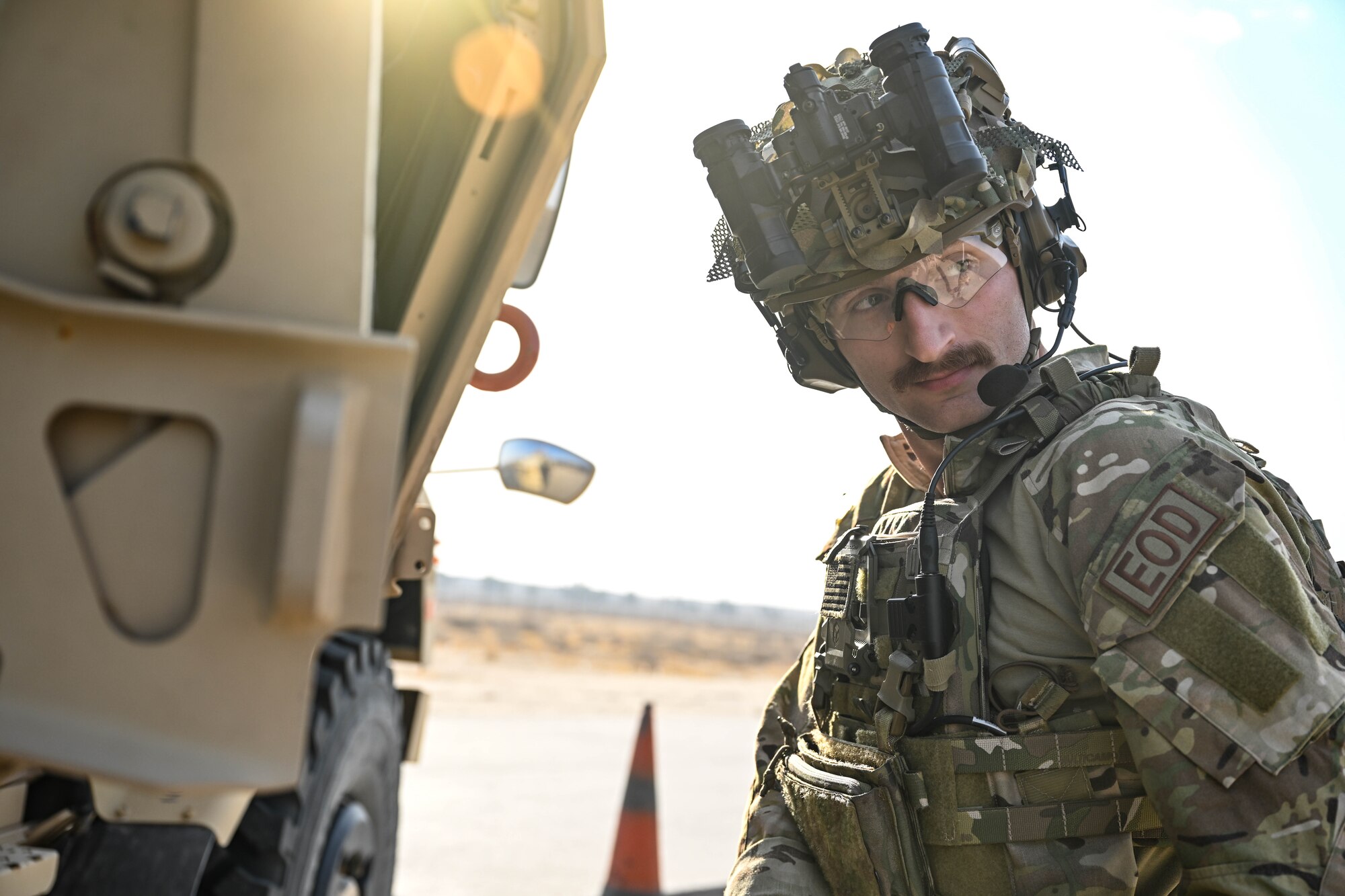 A man in uniform looks over his shoulder.