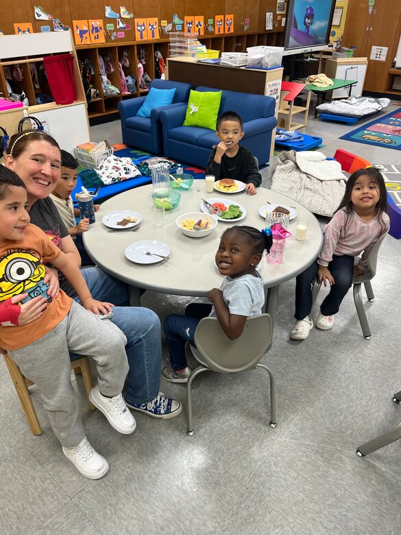 A teacher and some of her pre-k students enjoy lunch at Daegu Elementary in South Korea. The Louisville District equipped the school and more than 200 classrooms around the globe with furniture and curriculum prior to the new 2024-2025 school year.