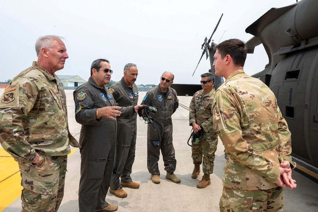 Lt. Gen. Carlos Chavez, the Peruvian Air Force Chief of Staff, second from left, asks about the capabilities of a UH-60 Black Hawk helicopter at Shepherd Field, Martinsburg, West Virginia, June 6, 2023.  Engagements such as this have been enabled through a long-standing partnership between the West Virginia National Guard and the Air Force Culture and Language Center that has connected Language Enabled Airman Program Scholars as interpreters for mobile training events. (U.S. Air National Guard photo by Senior Master Sgt. Emily Beightol-Deyerle)