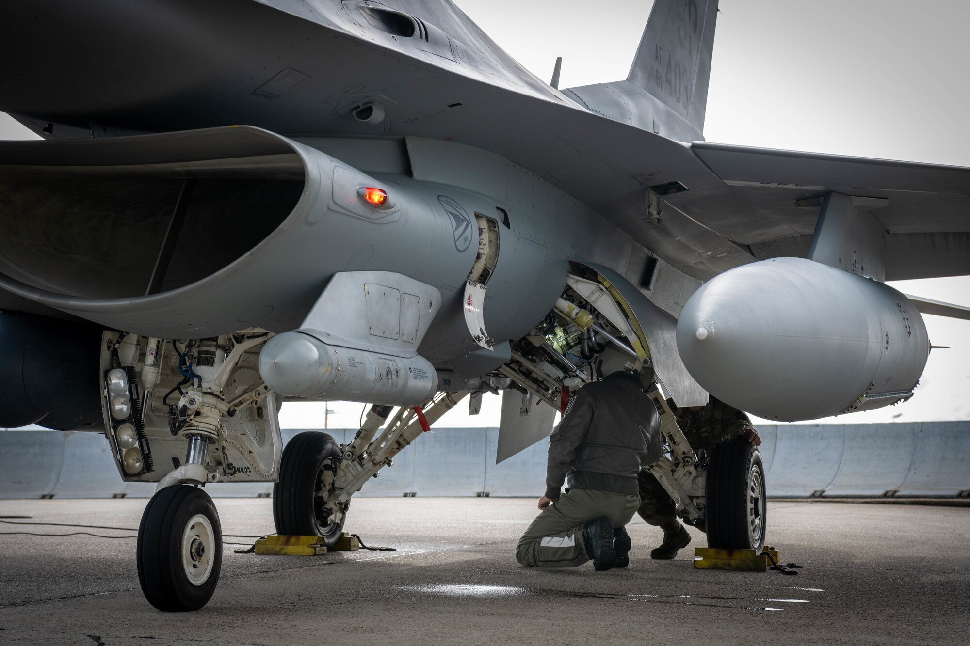 German Luftwaffe maintainer checks the side of an F-16.