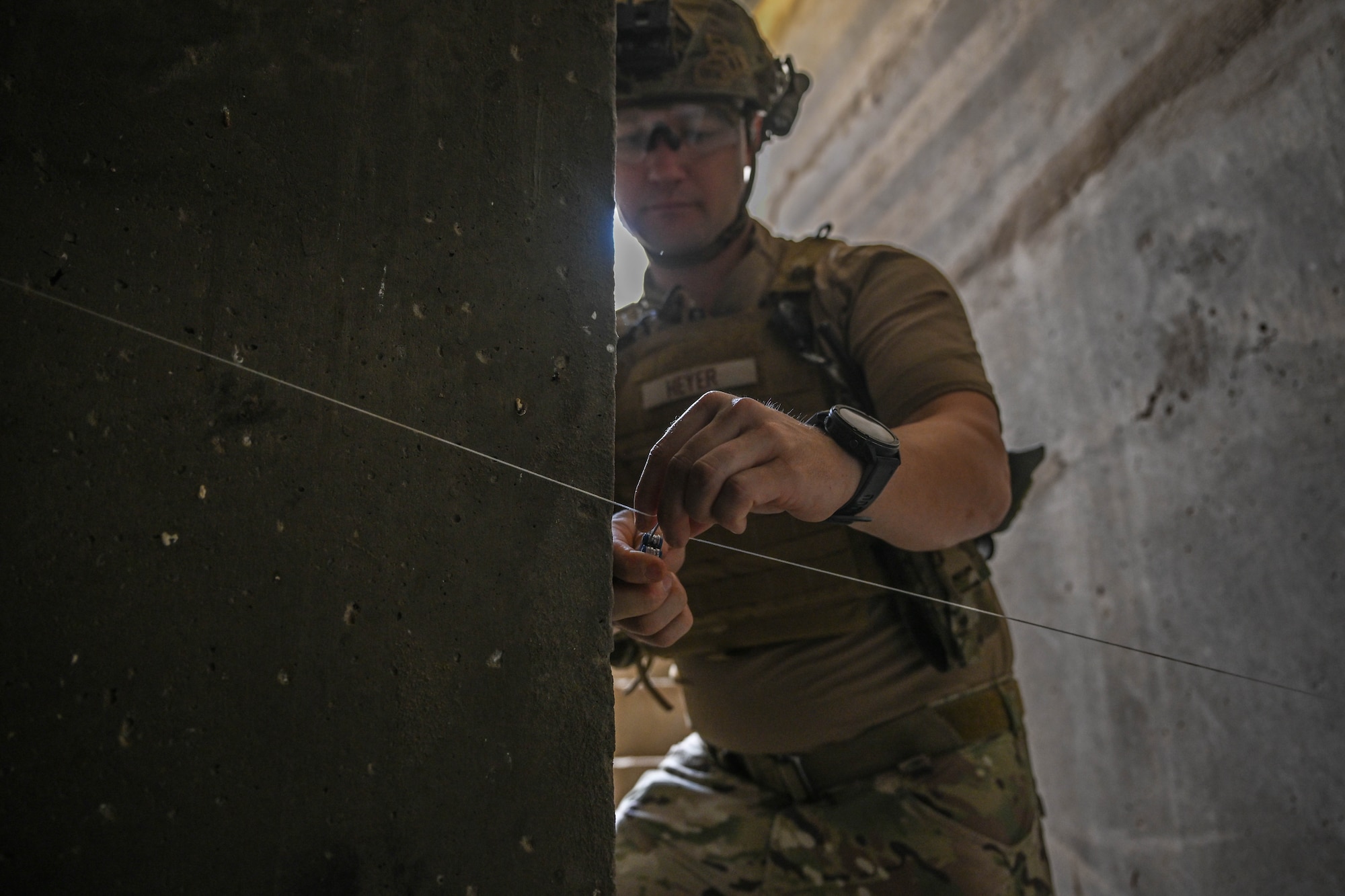 A man in uniform cuts a string.