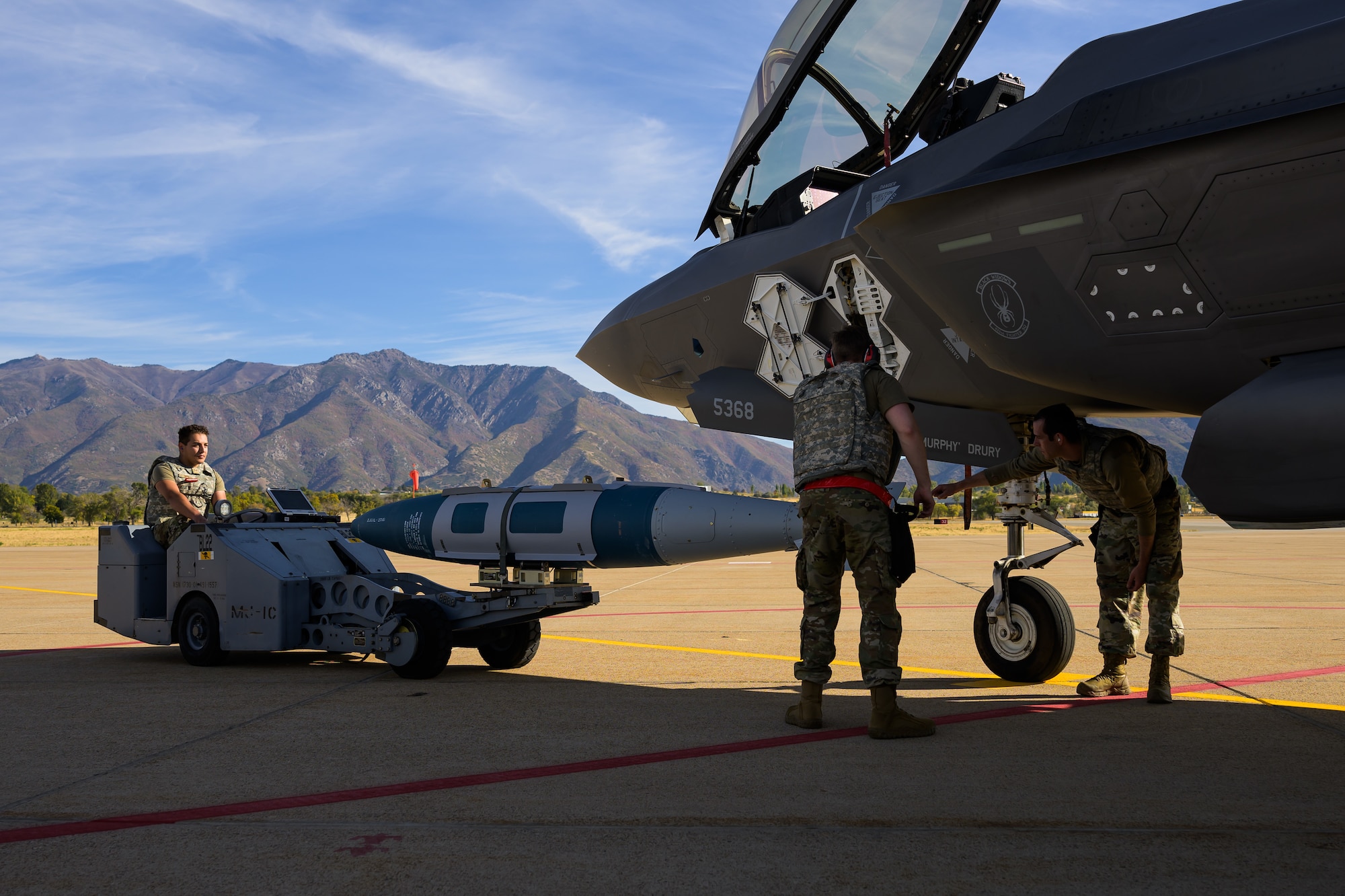 A photo of maintenance Airmen loading and fueling and preparing an F-35A Lightning II for launch.