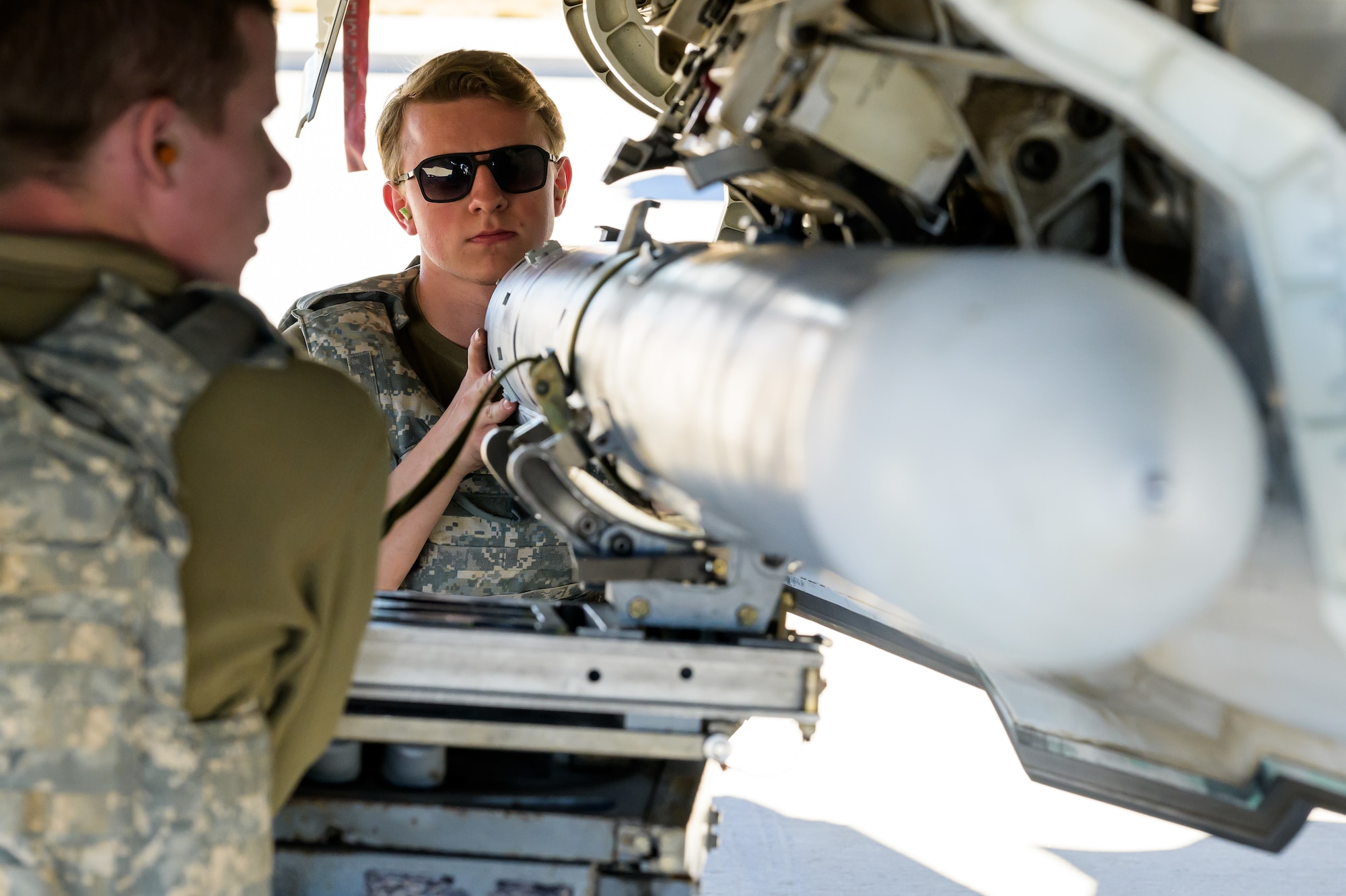 A photo of maintenance Airmen loading and fueling and preparing an F-35A Lightning II for launch.
