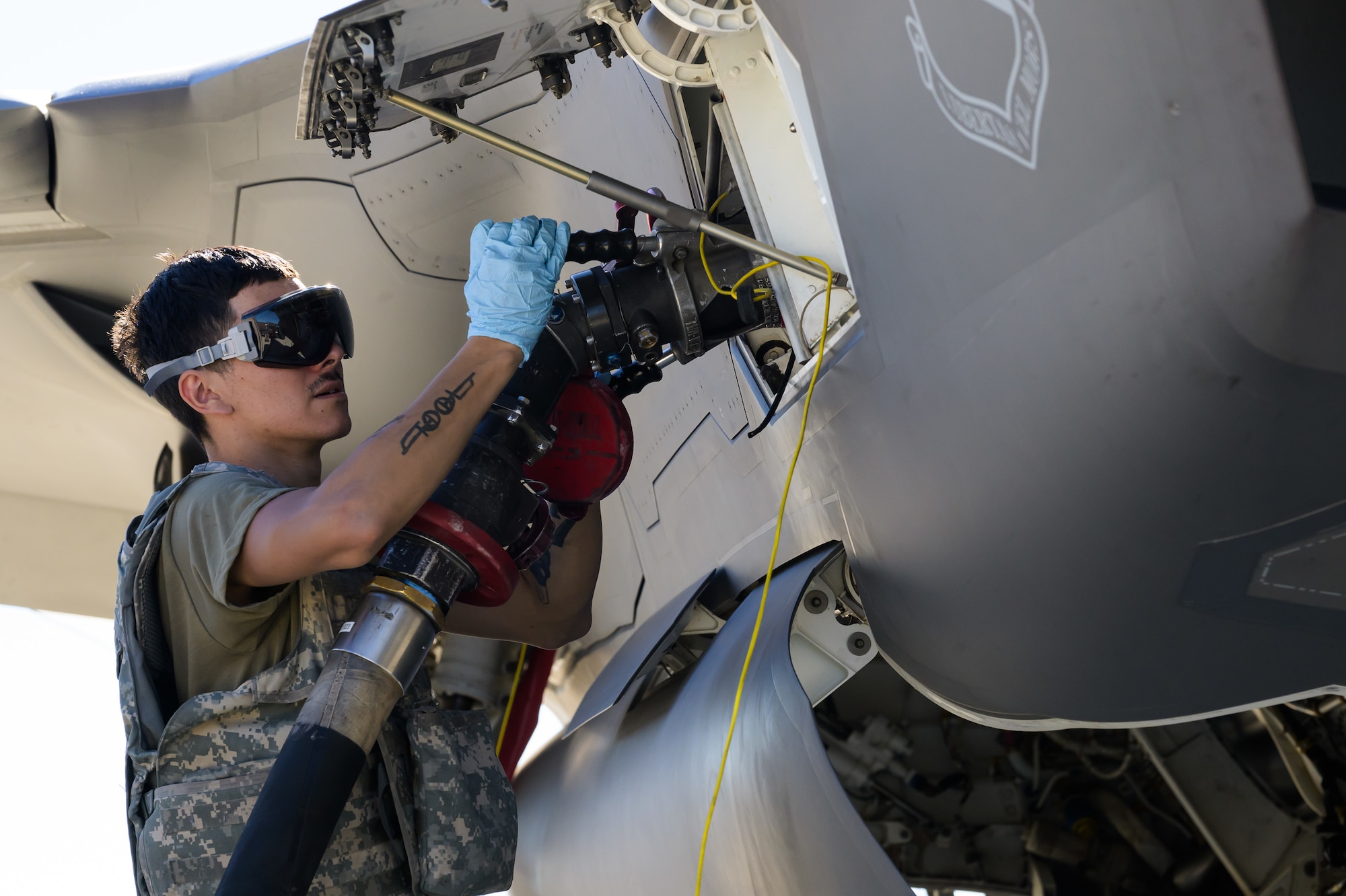 A photo of maintenance Airmen loading and fueling and preparing an F-35A Lightning II for launch.