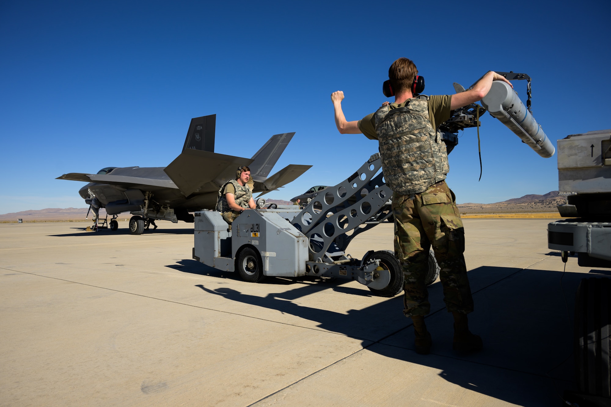 A photo of maintenance Airmen loading and fueling and preparing an F-35A Lightning II for launch.
