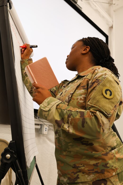 Staff Sgt. Quanshay Marshall, training and exercise NCOIC, 1st Theater Sustainment Command, documents progress during a culminating training exercise, October 10, 2024, Fort Cavazos, Texas. In collaboration with the 120th Infantry Division West trainers, Soldiers assigned to the 1st TSC, 3rd Expeditionary Sustainment Command, 34th Division Sustainment Brigade, and the 364th ESC, trained and prepared Soldiers with the 17th Sustainment Brigade for their upcoming deployment in the U.S. Central Command area of responsibility.