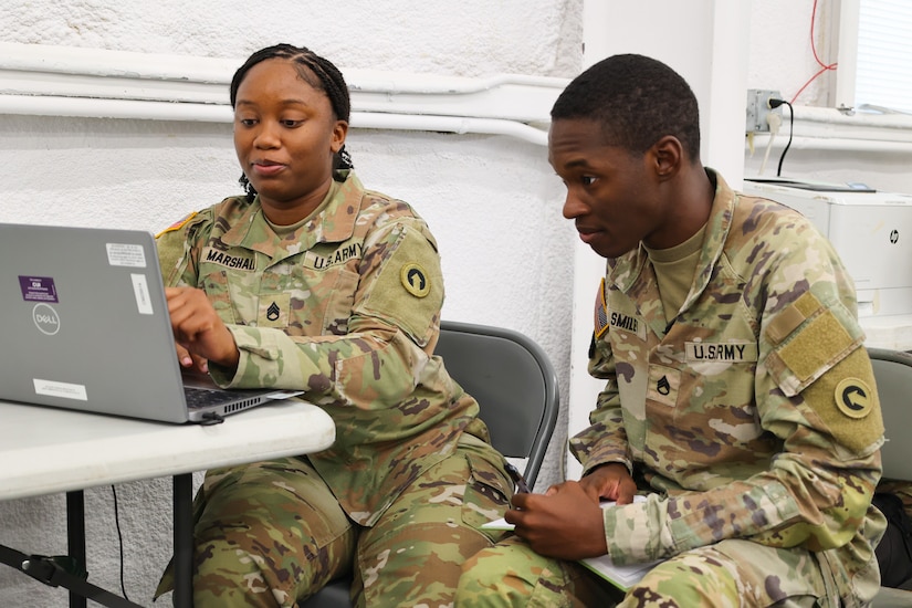 Staff Sgt. Quanshay Marshall, training and exercise NCOIC, 1st Theater Sustainment Command, and Staff Sgt. Patrick Smiley, ammunition inspector NCO, 1st TSC, work at the 17th Sustainment Brigade's culminating training exercise, October 10, 2024, Fort Cavazos, Texas. The 17th SB will soon deploy for a 9-month rotation in U.S. Central Command area of responsibility.