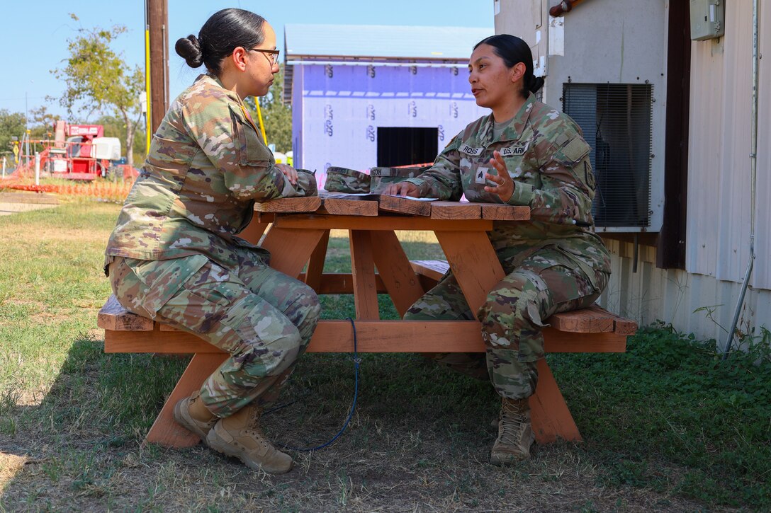 Staff Sgt. Evelyn Roses-Flores, victim advocate, 17th Sustainment Brigade, participates in a live, role-play scenario as part of the culminating training exercise, October 12, 2024, Fort Cavazos, Texas. Sgt. Jeanneth Bolton, automated logistics NCO, 1st Theater Sustainment Command plays the role of the person filing a report to help make the training realistic.