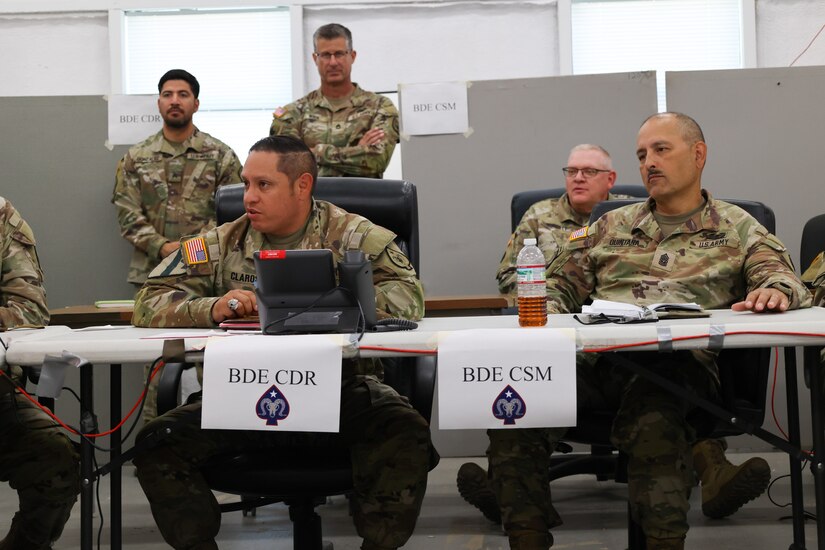 Col. Joseph Claros, brigade Commander, 17th Sustainment Brigade, and Command Sgt. Maj. Daniel Quintana, senior enlisted advisor, 17th SB, are briefed by Soldiers from each section about their process of solving issues during their culminated training exercise, October 12, 2024, Fort Cavazos, Texas. The 17th SB will soon deploy for a 9-month rotation in U.S. Central Command area of responsibility.