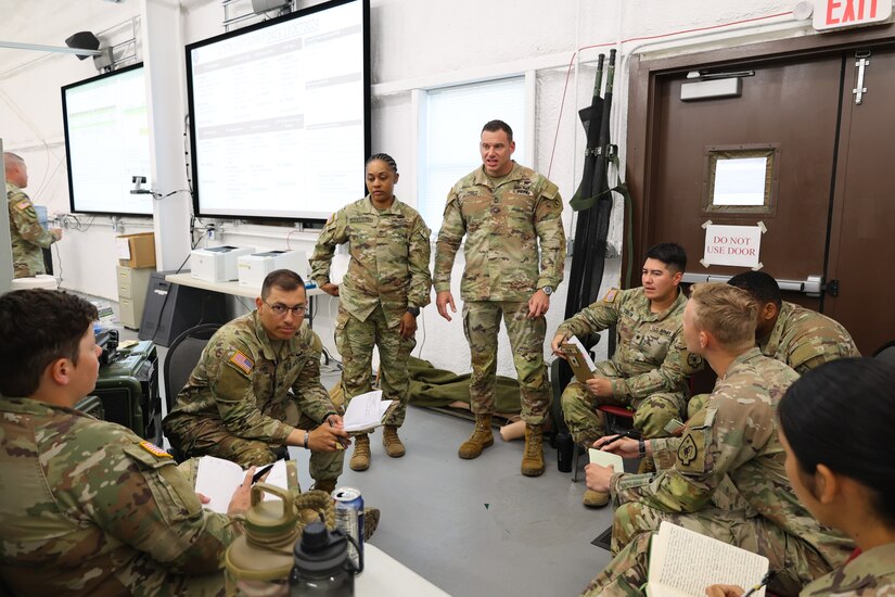 Master Sgt. Nicholas Reasons, combat medic, 1st Theater Sustainment Command, speaks with combat medics assigned to the 17th Sustainment Brigade, October 13, 2024, Fort Cavazos, Texas, during the unit's culminating training exercise. The 17th SB will soon deploy for a 9-month rotation in U.S. Central Command area of responsibility.