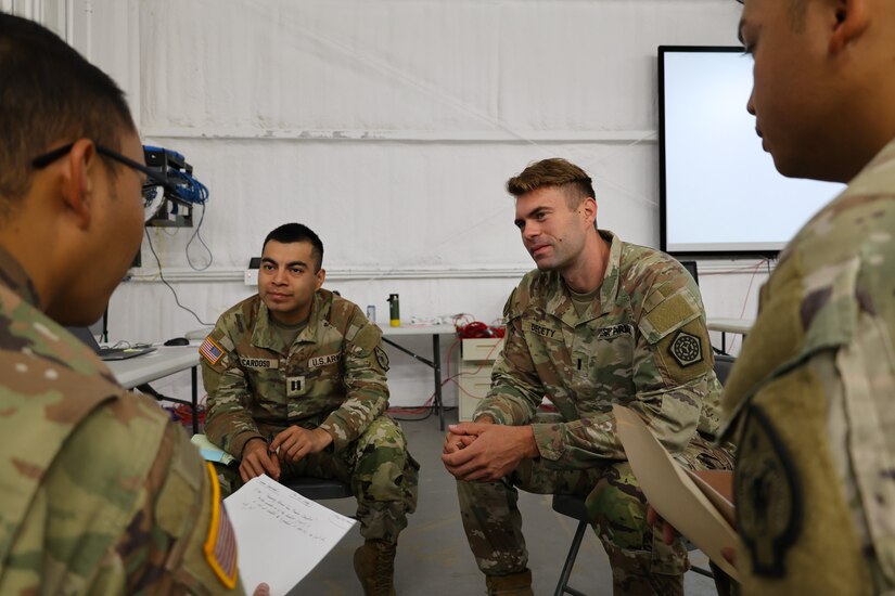 First Lt. Nathan Decety, financial manager, 34 Infantry Division Sustainment Brigade, answers questions from Soldiers assigned to the 17th Sustainment Brigade finance office during the unit's culminating training exercise, October 13, 2024, Fort Cavazos, Texas.