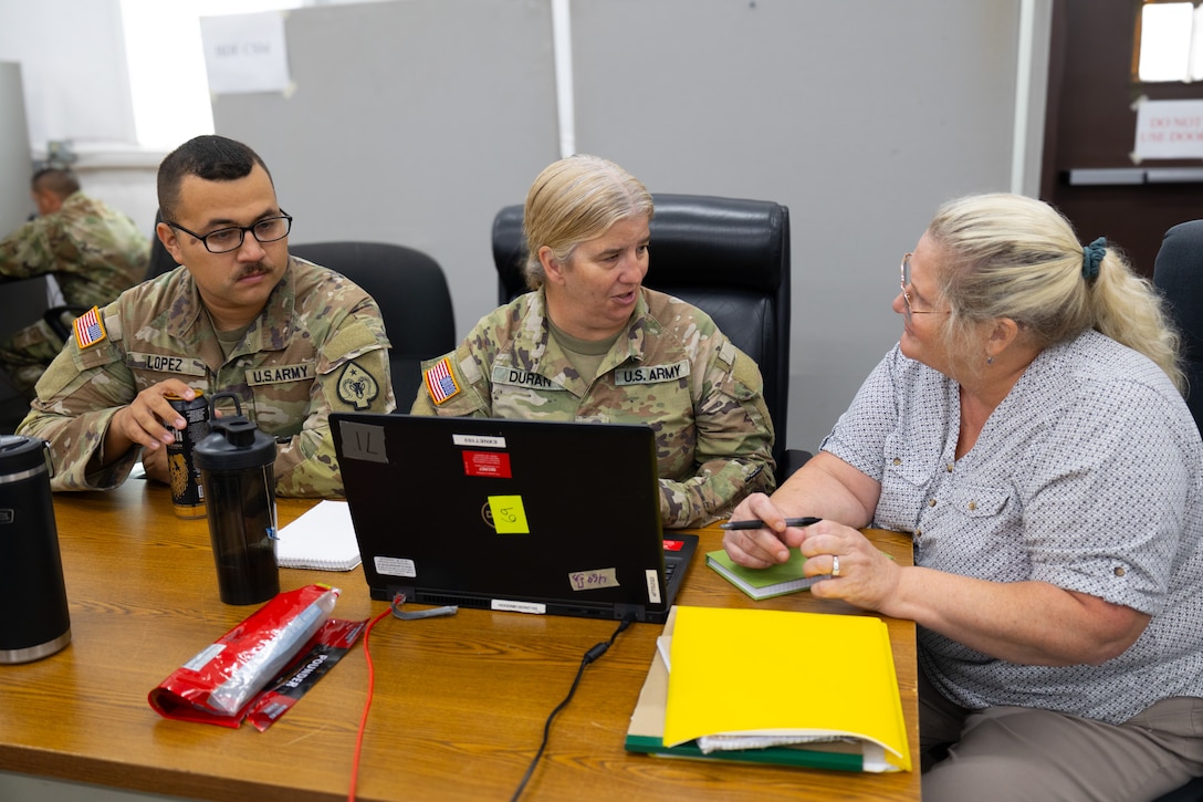 Barbara Gersna, deputy public affairs officer, 1st Theater Sustainment Command, trains Staff Sgt Zandra Duran and Sgt. Adrianne Lopez, mass communications NCOs, 17th Sustainment Brigade, during their culminating training exercise, October 7, 2024. The CTE is designed to prepare units for their upcoming deployment in theater. The 17th SB will soon deploy for a 9-month rotation in U.S. Central Command area of responsibility.