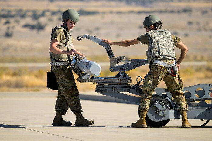 A photo of maintenance Airmen loading and fueling and preparing an F-35A Lightning II for launch.