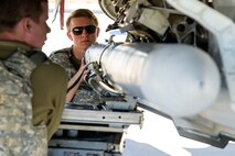 A photo of maintenance Airmen loading and fueling and preparing an F-35A Lightning II for launch.