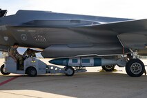 A photo of maintenance Airmen loading and fueling and preparing an F-35A Lightning II for launch.
