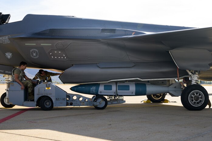 A photo of maintenance Airmen loading and fueling and preparing an F-35A Lightning II for launch.