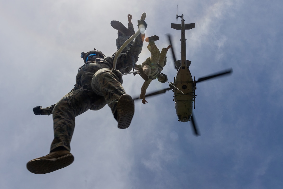 Marines practice helicopter rope suspension techniques with a UH-1Y Venom helicopter during a course at Camp Hansen in Okinawa, Japan, Sept. 26, 2024.