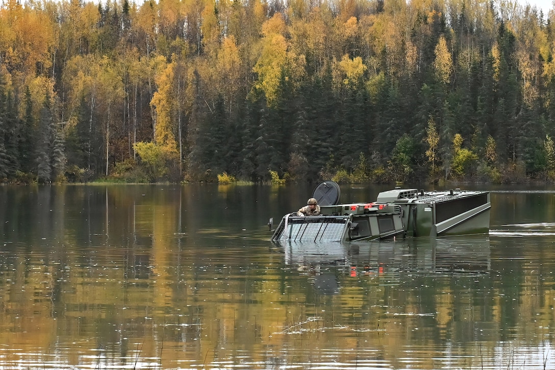 A cold weather all-terrain vehicle moves across Gwen Lake during new equipment training for select 11th Airborne Division soldiers at Joint Base Elmendorf-Richardson, Alaska, Sept. 26, 2024.