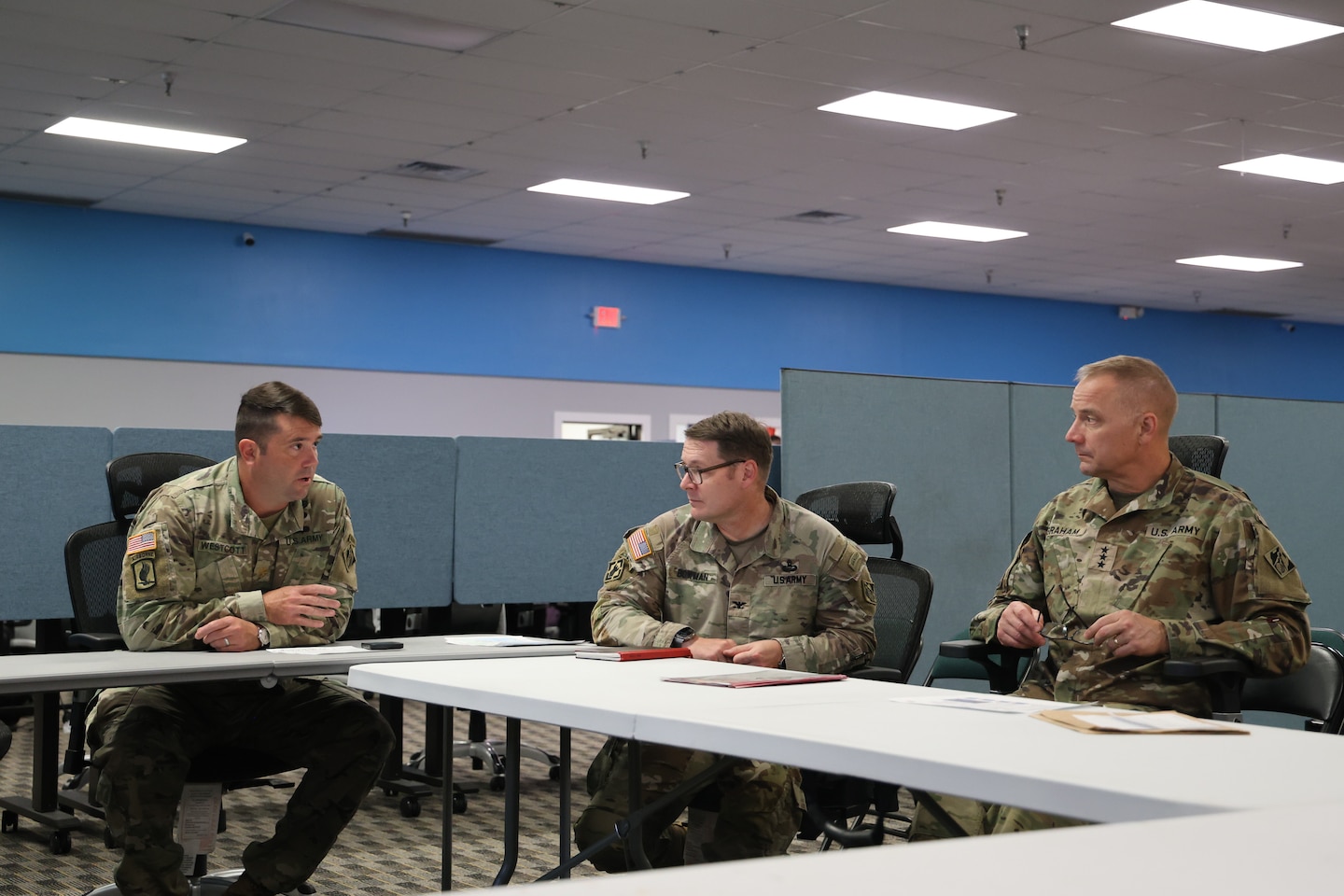 U.S. Army Corps of Engineers Jacksonville District Deputy Commander, Maj. Matt Westcott, District Commander, Col. Brandon Bowman and Chief of Engineers Lt. Gen. William H. Graham discuss the Hurricane Milton Blue Roof mission Oct. 29 at the Emergency Field Office in Sarasota, Florida. During Graham’s visit, he recognized several members for their stellar efforts on the Operation Blue Roof program and the general response. He also met with a homeowner from the Sarasota community who recently had a Blue Roof installed. (U.S. Army photo by Brooks O. Hubbard, U.S. Army Corps of Engineer)