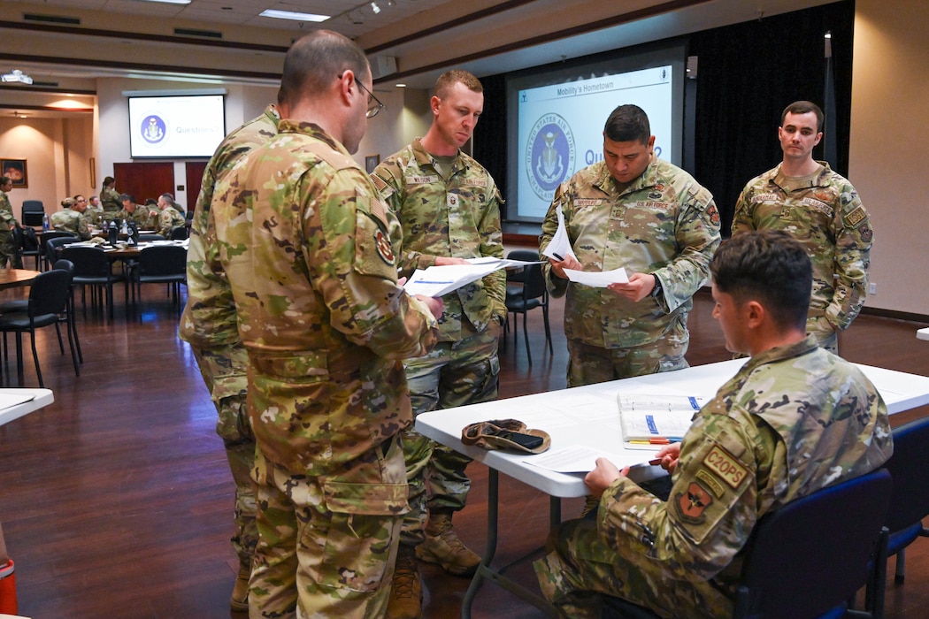 Leadership from the 97th Air Mobility Wing (AMW) Wing Staff Agencies speak to Senior Airman Cody Brewer, 97 AMW command post emergency operations controller, during a casualty response training at Altus Air Force Base, Oklahoma, Oct. 21, 2024. During the exercise, commanders were provided with realistic scenarios designed to challenge their decision-making skills and response strategies. (U.S. Air Force photo by Senior Airman Miyah Gray)