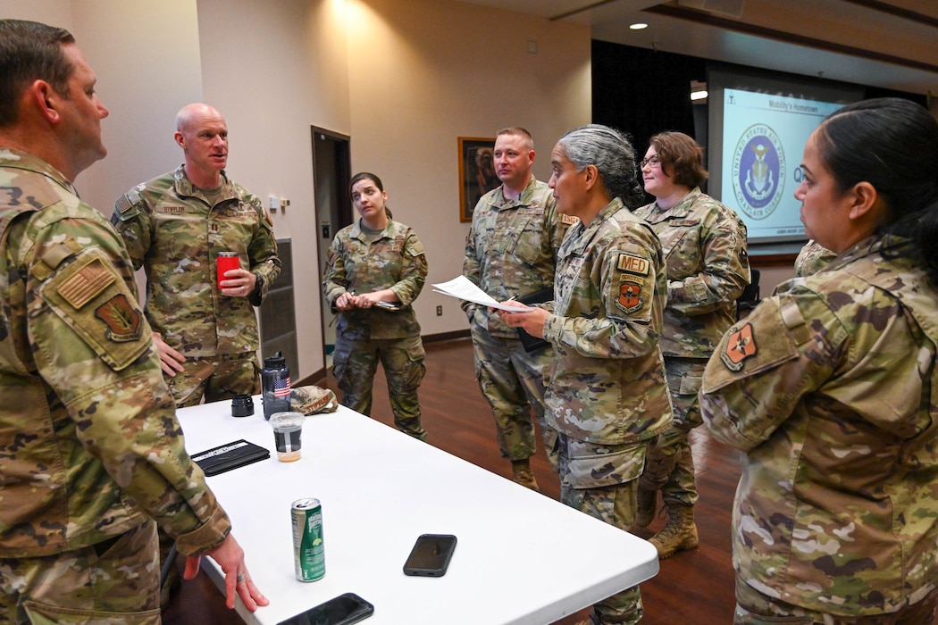 U.S. Air Force Capt. Jamie Stiffler, 97th Air Mobility Wing (AMW) deputy wing chaplain, speaks to Lt. Col. Shanti Jones, 97th Operational Medical Readiness Squadron commander, along with Airmen from across the 97 AMW during a casualty response training at Altus Air Force Base, Oklahoma, Oct. 21, 2024. During a crisis, the chaplain provides spiritual support, counseling and emotional care to service members and their families. (U.S. Air Force photo by Senior Airman Miyah Gray)