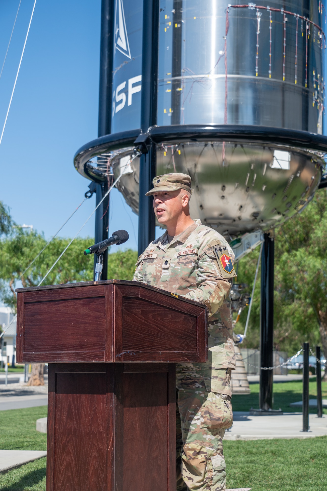 U.S. Air Force Lt. Col. Sean Granier, commander of the 61st Civil Engineer and Logistics Squadron, gives remarks during the ribbon cutting ceremony for the Centaur III propellant tank artifact dedication at Los Angeles Air Force Base, Calif., Oct. 18, 2024. The 61 CELS was integral in the installation of the display which came as the culmination of a multi-year effort made possible by the collaboration between the U.S. Space Force, the U.S. Air Force, industry partners and the Space and Missile Heritage Center supporting the command’s public history and educational missions. (U.S. Space Force photo by Van Ha)