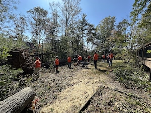 Volunteers with Samaritan’s Purse assist with tree removal after the devastation of Hurricane Helene in western North Carolina October 8, 2024. These volunteers are just a few of the thousands of people who have served through the organization in the western North Carolina relief effort. (Courtesy Photo)