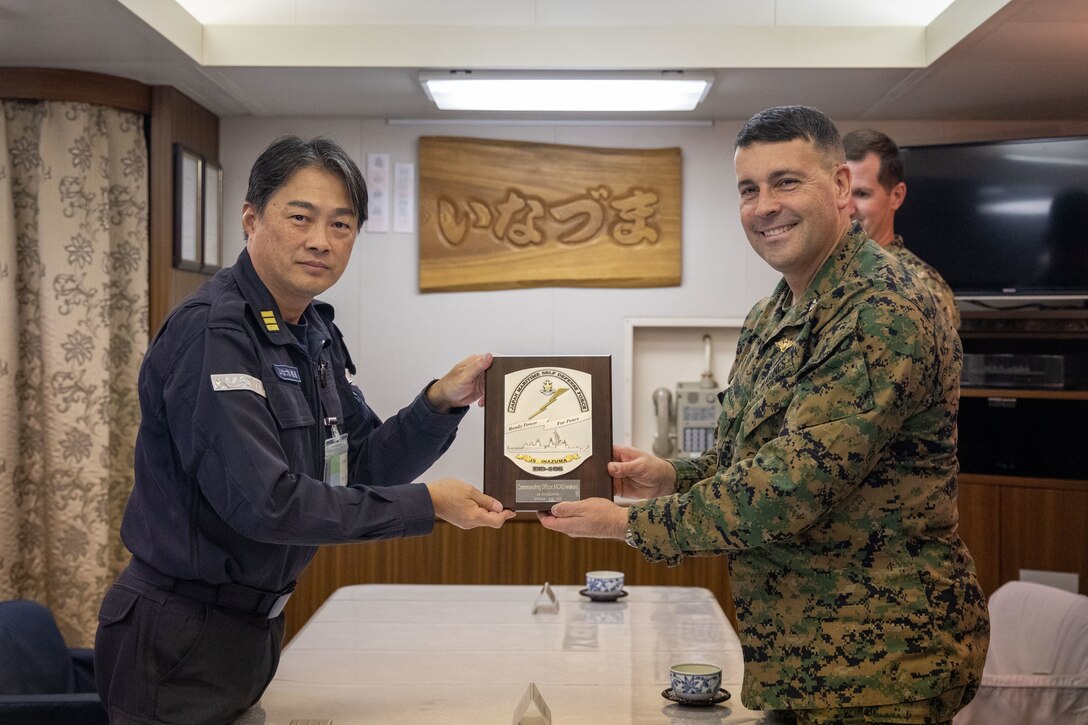 U.S. Marine Corps Col. Richard Rusnok, the commanding officer of Marine Corps Air Station Iwakuni, and a Pennsylvania native, right, and Japan Maritime Self-Defense Force Commander Jun Yoshida, the commanding officer of the JMSDF Murasame-class destroyer JS Inazuma (DD 105), left, pose for a photo during exercise Keen Sword 25 at MCAS Iwakuni, Japan, Oct. 29, 2024. Keen Sword is a biennial, joint and bilateral field-training exercise involving U.S. military and Japan Self-Defense Force personnel, designed to increase readiness and interoperability while strengthening the ironclad U.S.-Japan alliance. (U.S. Marine Corps photo by Sgt. Calah Thompson)