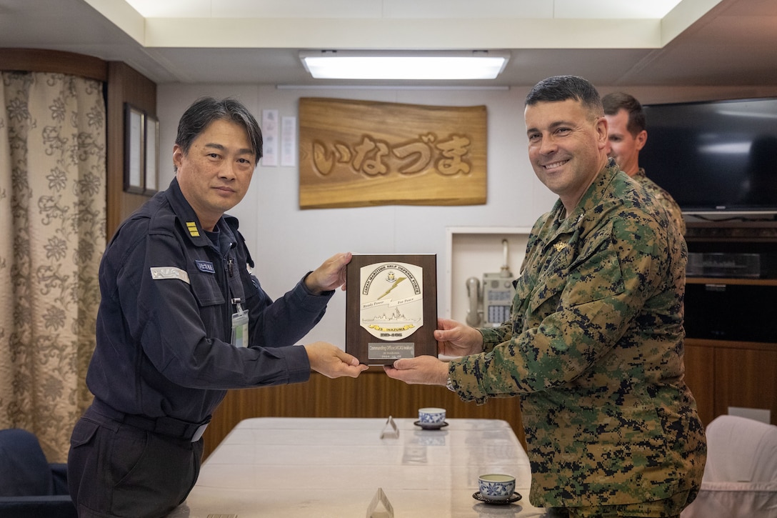U.S. Marine Corps Col. Richard Rusnok, the commanding officer of Marine Corps Air Station Iwakuni, and a Pennsylvania native, right, and Japan Maritime Self-Defense Force Commander Jun Yoshida, the commanding officer of the JMSDF Murasame-class destroyer JS Inazuma (DD 105), left, pose for a photo during exercise Keen Sword 25 at MCAS Iwakuni, Japan, Oct. 29, 2024. Keen Sword is a biennial, joint and bilateral field-training exercise involving U.S. military and Japan Self-Defense Force personnel, designed to increase readiness and interoperability while strengthening the ironclad U.S.-Japan alliance. (U.S. Marine Corps photo by Sgt. Calah Thompson)