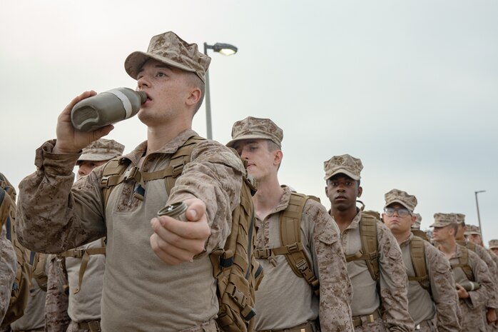 U.S. Marine Corps recruits with Charlie Company, 1st Recruit Training Battalion, stand in formation after a three-kilometer introduction hike at Marine Corps Recruit Depot San Diego, California, Oct. 10, 2024. During training, recruits conduct a series of progressively longer hikes to physically and mentally condition themselves and create combat readiness for any necessary future operations as the world’s force in readiness.  (U.S. Marine Corps photo by Cpl. Sarah M. Grawcock)