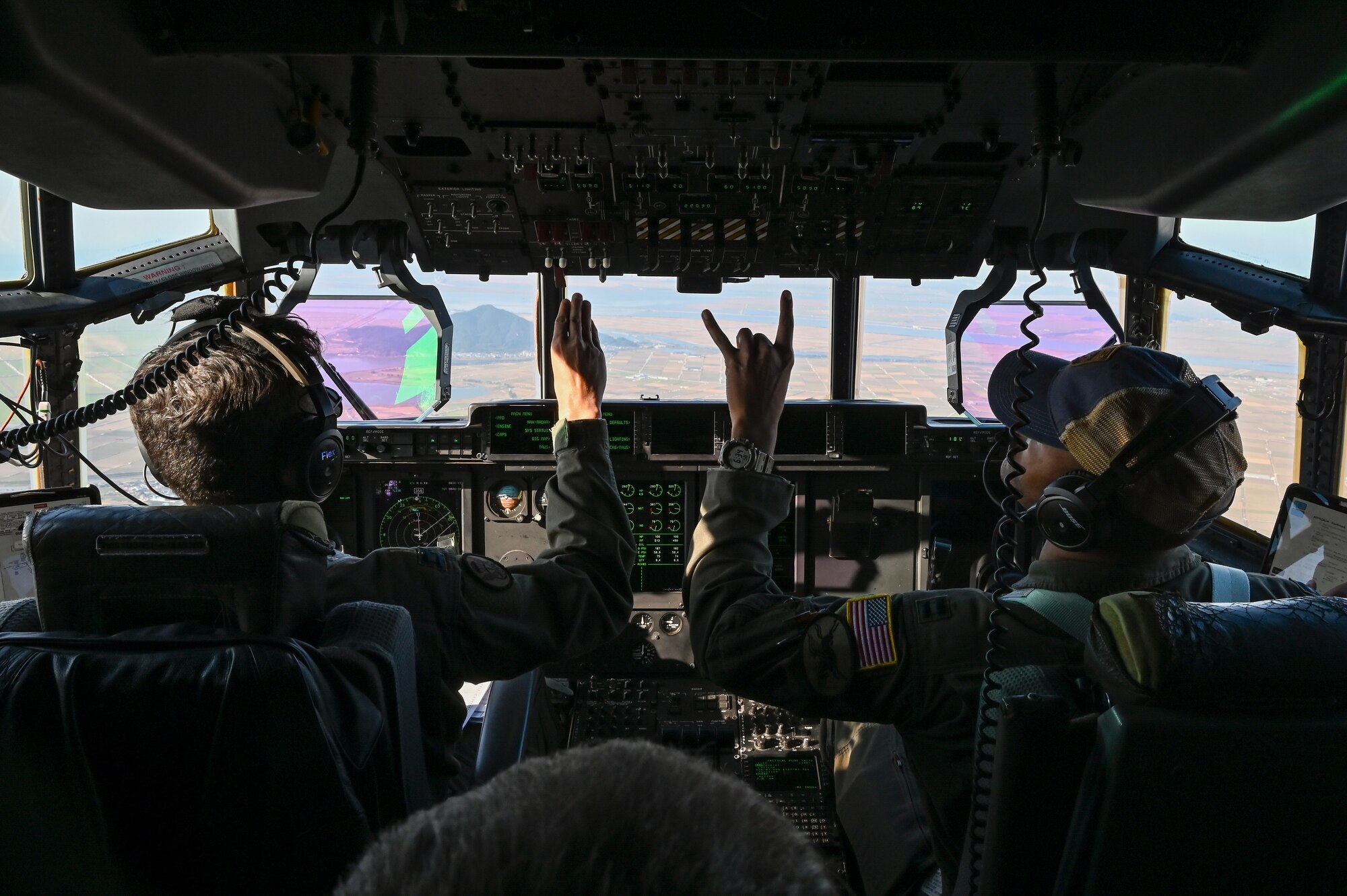 U.S. Air Force Capt. Simon Castro, left, and U.S. Air Force Capt. Brendan King, 36th Airlift Squadron C-130J Super Hercules pilots, fly a C-130J Super Hercules aircraft during high-altitude, high-opening proficiency jump training for Freedom Flag 24-1 at Kunsan Air Base, Republic of Korea.