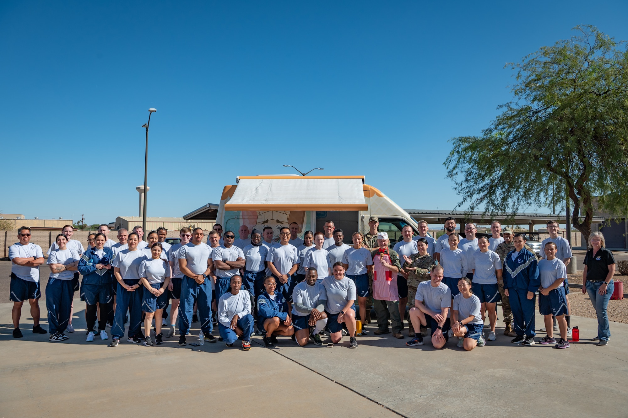 Members of the 944th Medical Squadron gather for a group photo following a squadron achievement celebration at Luke Air Force Base, Ariz., Oct. 20, 2024. The squadron celebrated 14 months of physical readiness without a single test failure, reflecting a cultural shift toward team-based fitness and mutual support. (U.S. Air Force photo by Tech. Sgt. Tyler J. Bolken)