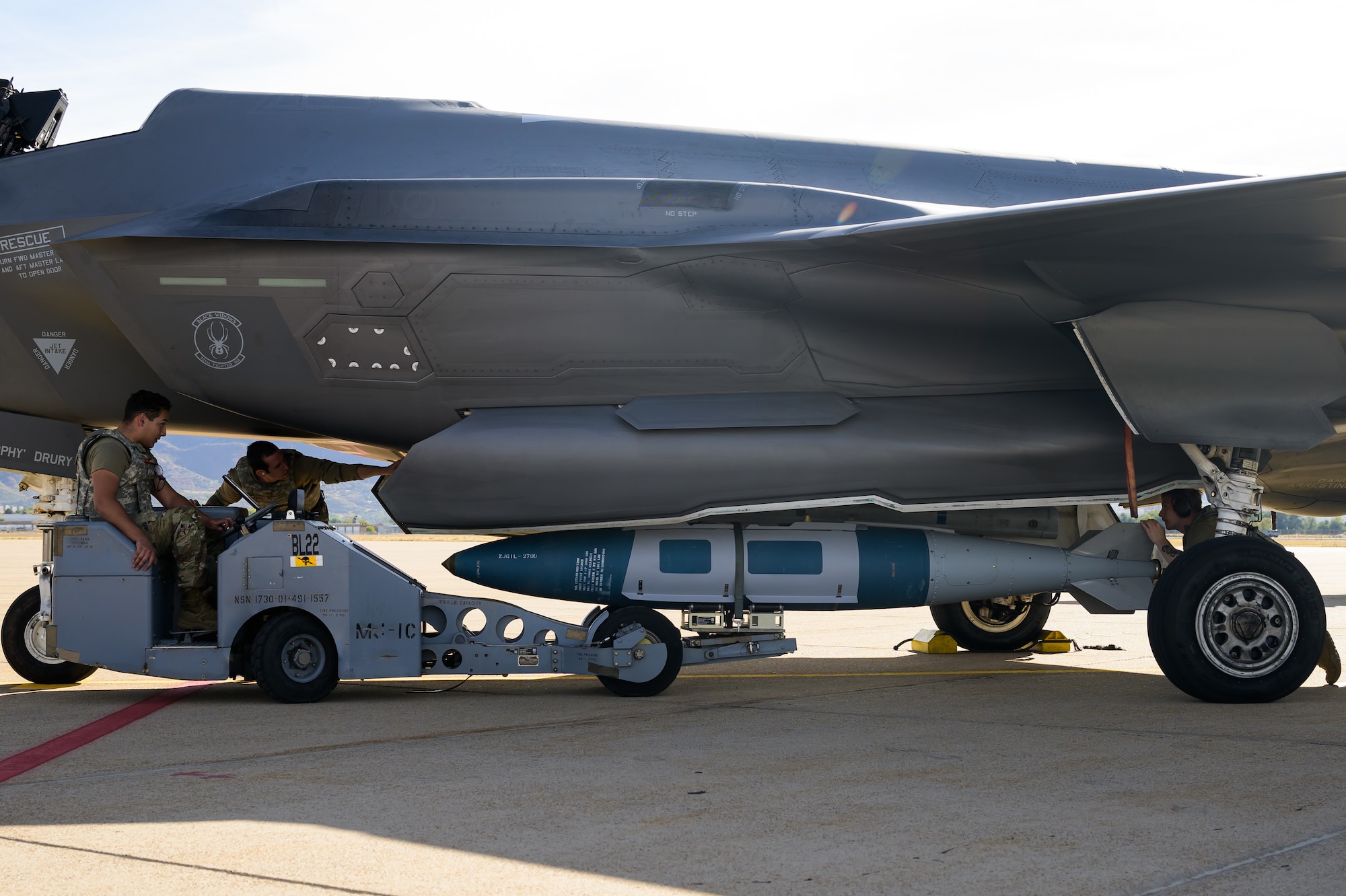 A photo of maintenance Airmen loading and fueling and preparing an F-35A Lightning II for launch.