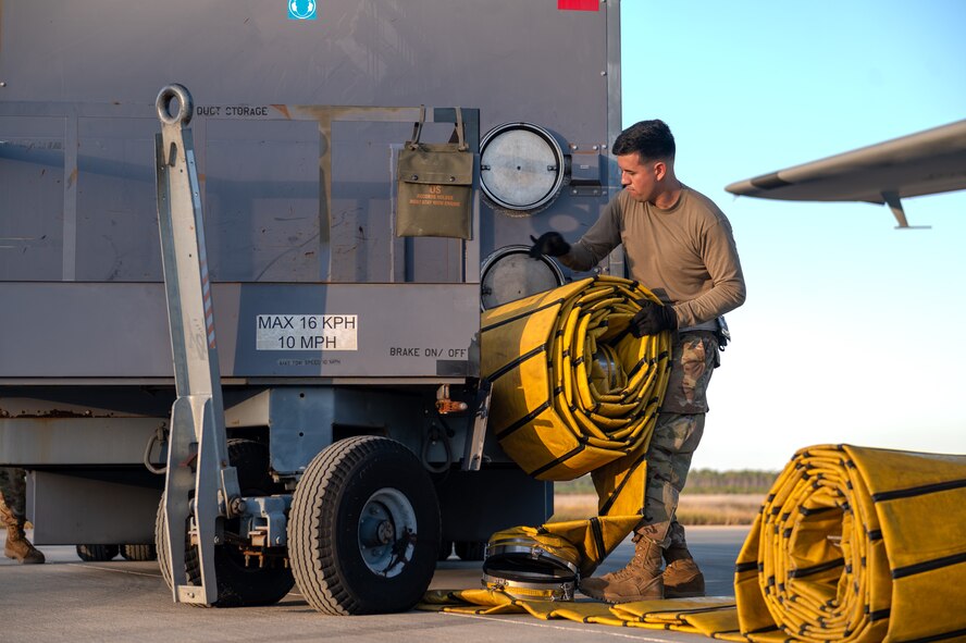 A U.S. Airman, assigned to the 4th Special Operations Aircraft Maintenance Squadron, prepares to connect pre-conditioned air units to an AC-130J Ghostrider gunship at Hurlburt Field, Florida, Oct. 23, 2024.