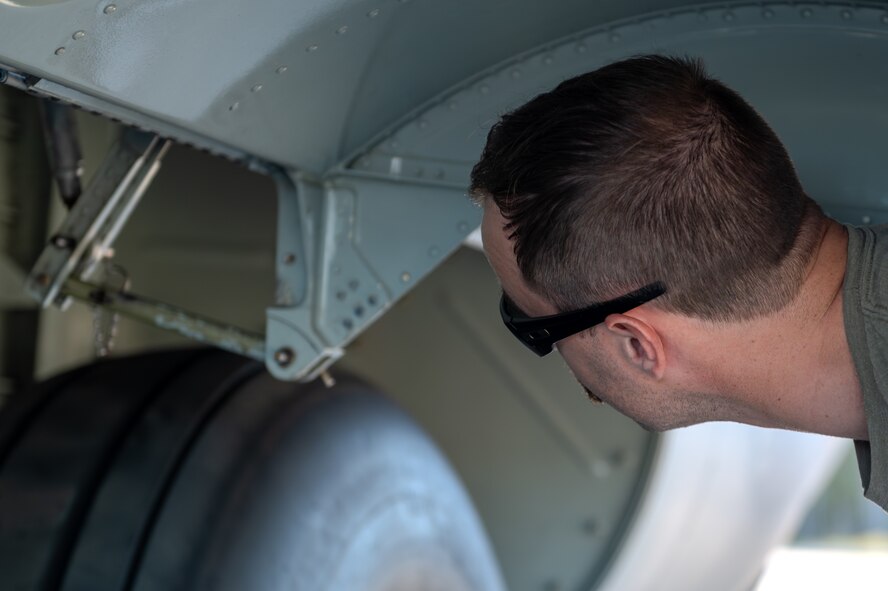 A U.S. Airman, assigned to the 4th Special Operations Squadron, inspects a landing gear door on an AC-130J Ghostrider gunship at Hurlburt Field, Florida, Oct. 23, 2024.