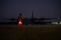 A 4th Special Operations Aircraft Maintenance Squadron crew chief stands by to marshal an AC-130J Ghostrider gunship at Hurlburt Field, Florida, Oct. 23, 2024.