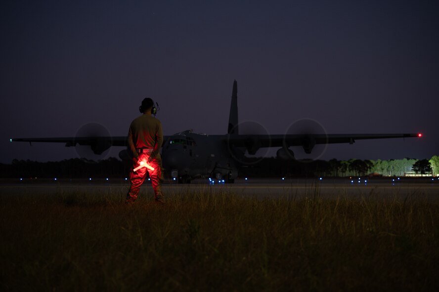 A 4th Special Operations Aircraft Maintenance Squadron crew chief stands by to marshal an AC-130J Ghostrider gunship at Hurlburt Field, Florida, Oct. 23, 2024.