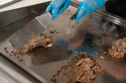 Airmen cooks steak