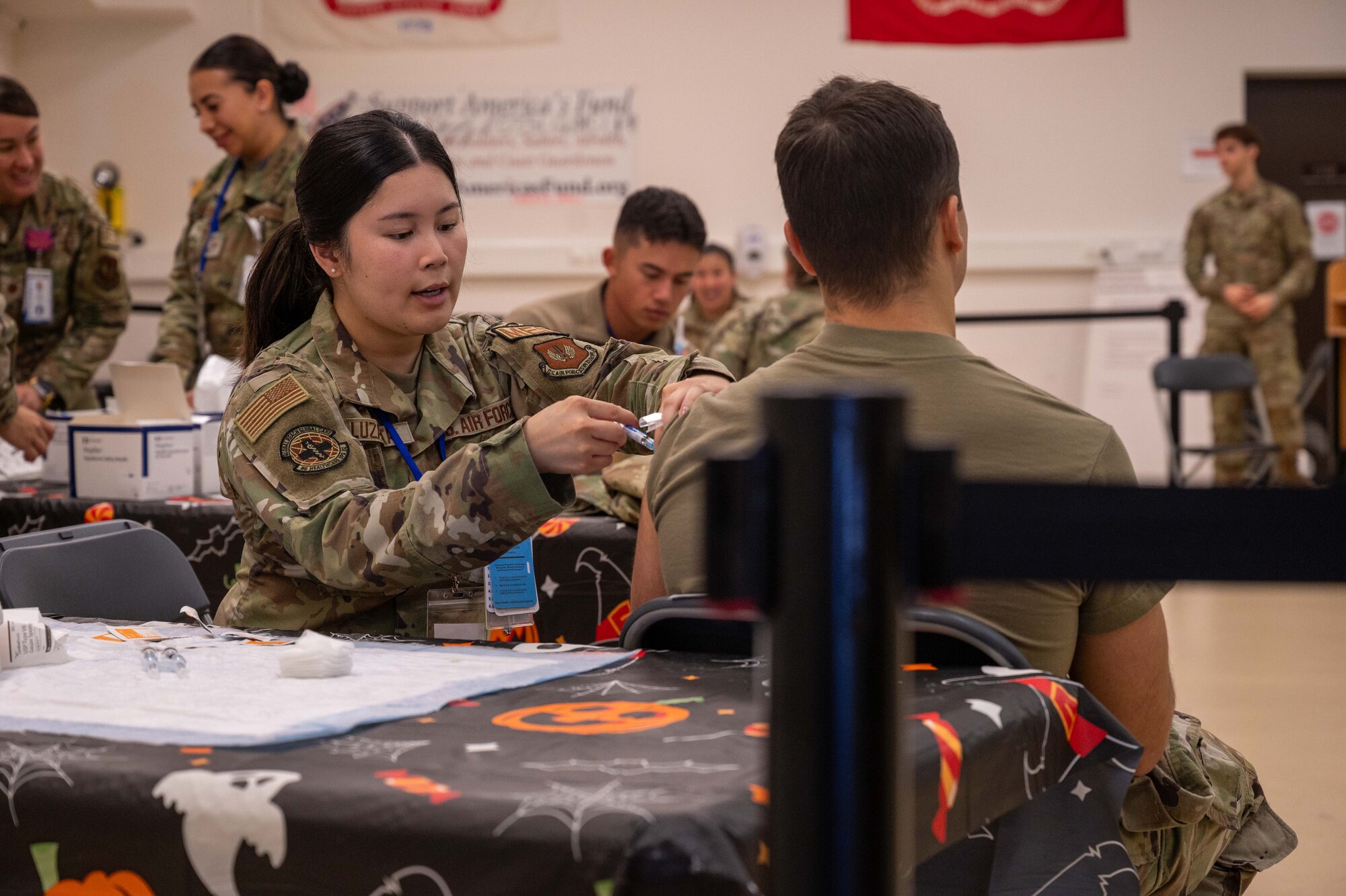 an airman gives a patient a flu shot