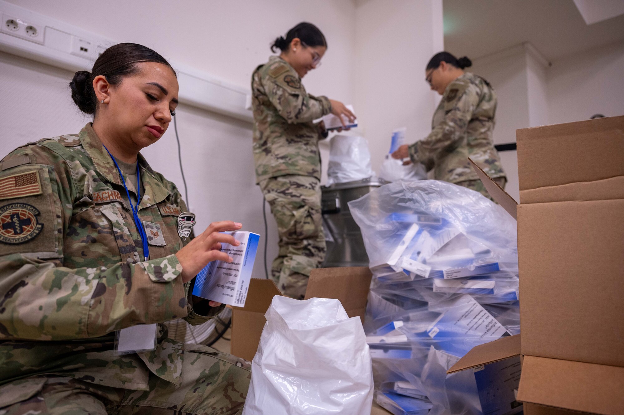 airmen unpackage flu vaccines