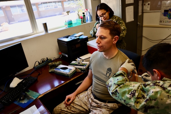 Sailors and hospital staff from Navy Medicine Readiness and Training Command (NMRTC) Twentynine Palms conduct a Shot Exercise (SHOTEX) session from Oct. 15–28, providing influenza vaccinations to personnel across various non-deployable units at the Marine Corps Air Ground Combat Center (MCAGCC). This particular session of a wider SHOTEX primarily focused on supporting the Marine Corps Communications-Electronics School (MCCES), with vaccinations also being administered to the Marine Corps Logistics Operations Group (MCLOG), Tactical Training Exercise Control Group (TTECG), Marine Air Ground Task Force Training Command (MAGTFTC), Headquarters Battalion, and other units U.S. Navy photo by Christopher C. Jones, NHTP/NMRTC Twentynine Palms public affairs officer).