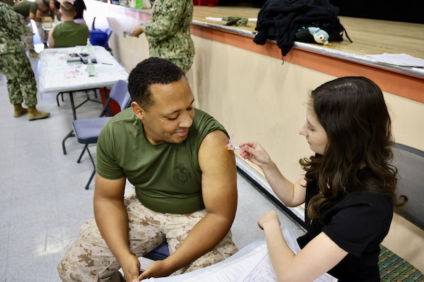 Sailors and hospital staff from Navy Medicine Readiness and Training Command (NMRTC) Twentynine Palms conduct a Shot Exercise (SHOTEX) session from Oct. 15–28, providing influenza vaccinations to personnel across various non-deployable units at the Marine Corps Air Ground Combat Center (MCAGCC). This particular session of a wider SHOTEX primarily focused on supporting the Marine Corps Communications-Electronics School (MCCES), with vaccinations also being administered to the Marine Corps Logistics Operations Group (MCLOG), Tactical Training Exercise Control Group (TTECG), Marine Air Ground Task Force Training Command (MAGTFTC), Headquarters Battalion, and other units U.S. Navy photo by Christopher C. Jones, NHTP/NMRTC Twentynine Palms public affairs officer).