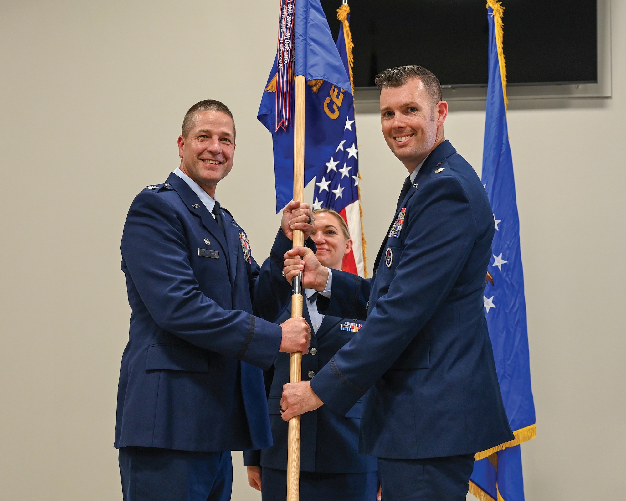 Col. Robert Wengerter, left, 445th Mission Support Group commander, passes the guidon to Maj. Jefferson Sweet, incoming 445th Civil Engineer Squadron commander, during a change of command ceremony at Wright-Patterson Air Force Base, Ohio, Oct. 5, 2024. Col. Jason Bordas, the outgoing CES commander, heads to Tyndall AFB, Fla.