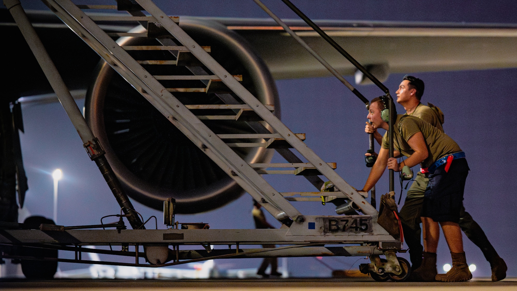 Airmen push stairs.